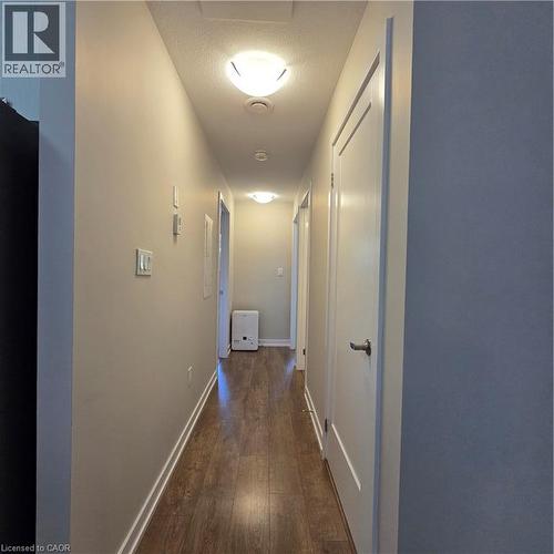 Hallway featuring wood-finish flooring, light neutral wall paint, and white trim - 20 Palace Place Unit# E9, Kitchener, ON - Indoor Photo Showing Other Room