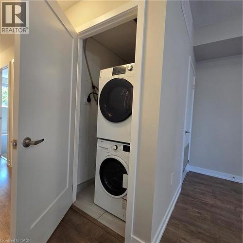 Dedicated laundry closet featuring a stacked washer and dryer - 20 Palace Place Unit# E9, Kitchener, ON - Indoor Photo Showing Laundry Room