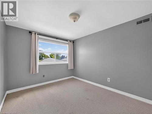 Room with neutral gray walls, white trim, and light beige carpet - 143 Cromwell Crescent, Hamilton, ON - Indoor Photo Showing Other Room