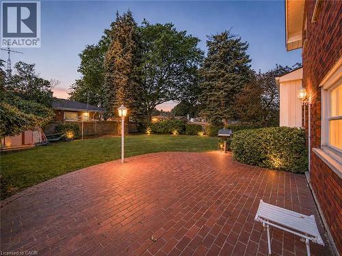 Expansive brick paver patio featuring a central lamppost - 143 Cromwell Crescent, Hamilton, ON - Outdoor