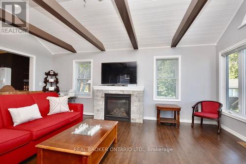 Living room features gas fireplace & a view! - 5818 Victoria Park Road, Ramara, ON - Indoor Photo Showing Living Room With Fireplace