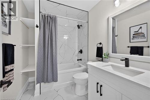 Bathroom featuring a white vanity with a quartz-finish countertop and integrated sink - 101 Loyalist Drive, Hamilton, ON - Indoor Photo Showing Bathroom