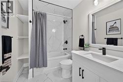 Bathroom featuring a white vanity with a quartz-finish countertop and integrated sink - 