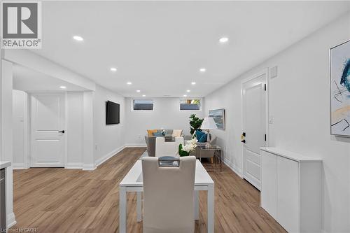 Open-concept room featuring wood-finish flooring, recessed lighting, white walls, white doors, and a built-in storage unit - 101 Loyalist Drive, Hamilton, ON - Indoor