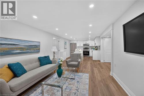 Open-concept living space featuring wood-finish flooring, recessed lighting, and white walls - 101 Loyalist Drive, Hamilton, ON - Indoor Photo Showing Living Room
