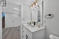 Bathroom vanity featuring a rectangular undermount sink, a matte black faucet, and a quartz countertop - 