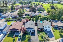 Residential neighborhood featuring a variety of architectural styles, mature trees, and green spaces - 