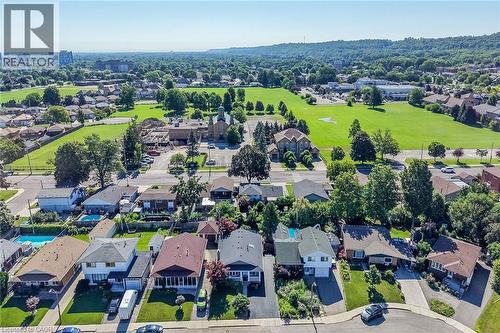 Aerial perspective showcasing a residential street with diverse architectural styles, individual driveways, and established landscaping - 101 Loyalist Drive, Hamilton, ON - Outdoor With View