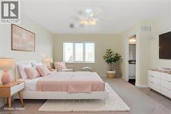 Expansive room featuring light-toned carpeting and a ceiling fan with integrated lighting - 