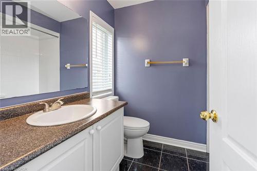 Bathroom featuring a white vanity with a brown countertop, white ceramic sink, and chrome faucet - 2248 Seton Crescent, Burlington, ON - Indoor Photo Showing Bathroom
