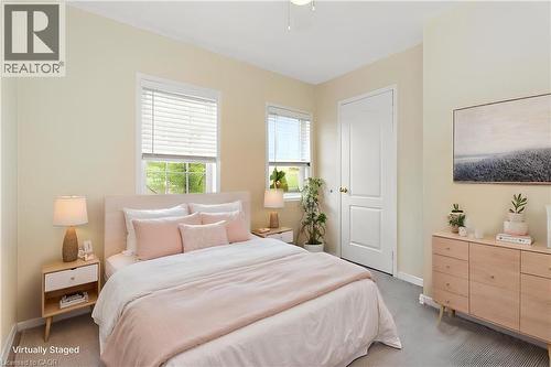 Bedroom featuring two windows with blinds, a solid core door, and neutral-toned walls - 2248 Seton Crescent, Burlington, ON - Indoor Photo Showing Bedroom
