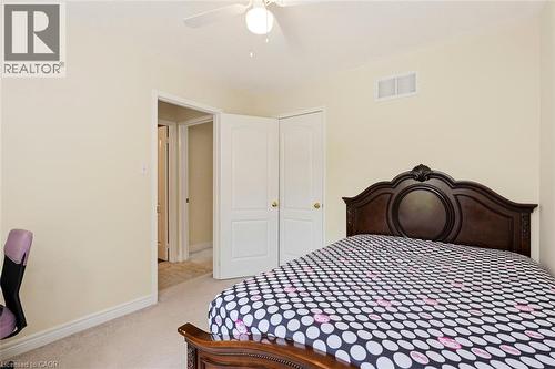Neutral-toned bedroom featuring carpet flooring, white baseboards, and a ceiling fan - 2248 Seton Crescent, Burlington, ON - Indoor Photo Showing Bedroom