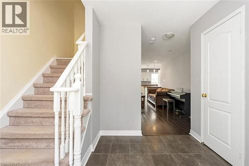 Foyer featuring large format tile flooring and a carpeted staircase with white balusters - 2248 Seton Crescent, Burlington, ON - Indoor Photo Showing Other Room