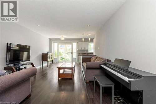 Open-concept living area featuring dark wood-finish flooring, light gray walls, and recessed ceiling lighting - 2248 Seton Crescent, Burlington, ON - Indoor Photo Showing Living Room