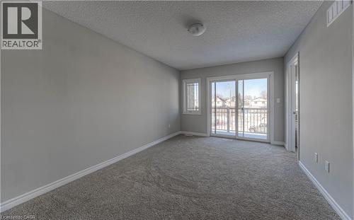 Room featuring grey carpeting, light grey wall paint, and white baseboards - 44 Harrison Drive, Cambridge, ON - Indoor Photo Showing Other Room