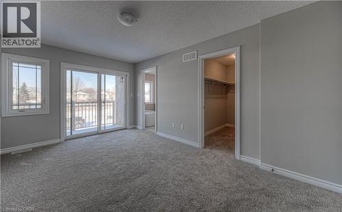 Spacious room featuring broadloom carpeting, light gray wall tones, and white trim - 44 Harrison Drive, Cambridge, ON - Indoor Photo Showing Other Room