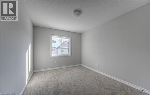Neutral-toned room with light gray walls, plush gray carpeting, and white baseboards - 44 Harrison Drive, Cambridge, ON - Indoor Photo Showing Other Room