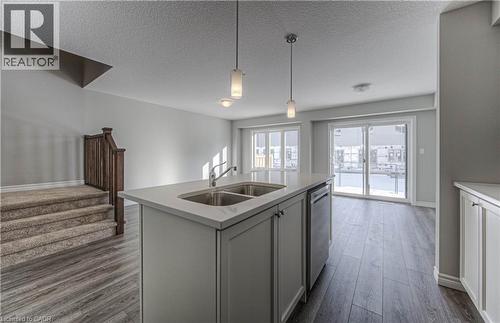 Kitchen island featuring a dual basin sink and polished chrome faucet - 44 Harrison Drive, Cambridge, ON - Indoor Photo Showing Kitchen With Double Sink