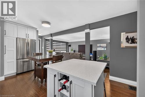 Kitchen island featuring a light-toned countertop and integrated wine storage - 386 Upper Kenilworth Avenue, Hamilton, ON - Indoor
