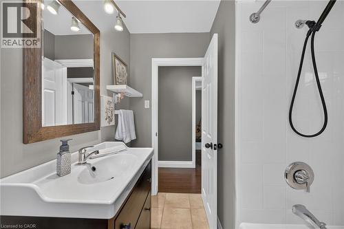 Bathroom featuring a vanity with an integrated sink, a large framed mirror, and track lighting - 386 Upper Kenilworth Avenue, Hamilton, ON - Indoor Photo Showing Bathroom