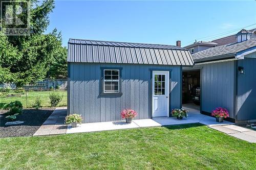 Detached shed featuring a metal roof, single window, and a white paneled door - 386 Upper Kenilworth Avenue, Hamilton, ON - Outdoor