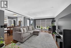 Living area featuring wood-finish flooring, recessed lighting, and a built-in fireplace - 