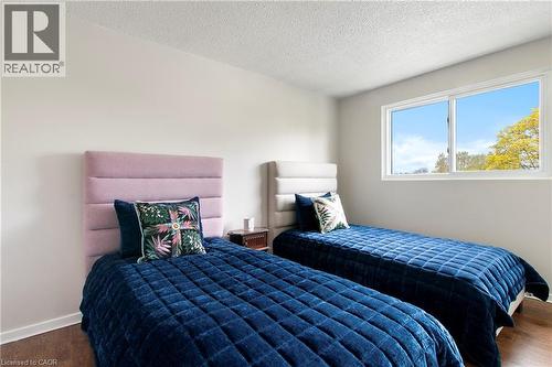 Bright interior space featuring a double-pane window, white trim, and wood-finish flooring - 29 Woodlawn Avenue, Brantford, ON - Indoor Photo Showing Bedroom