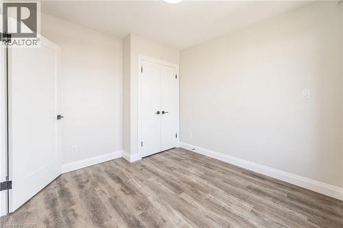 Interior room featuring wood-finish flooring and light-toned walls - 72 Erb Street E Unit# 103, Waterloo, ON - Indoor Photo Showing Other Room