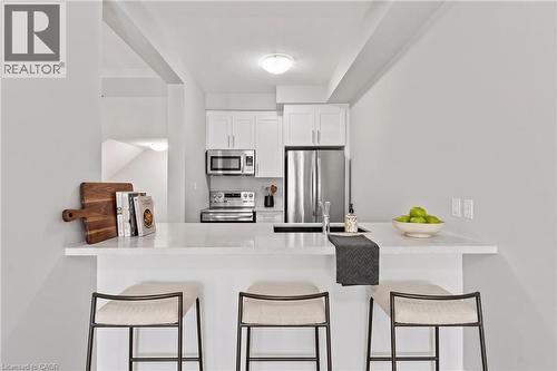 Virtually Staged  Breakfast bar - 13 Aqua Lane, Hamilton, ON - Indoor Photo Showing Kitchen With Stainless Steel Kitchen