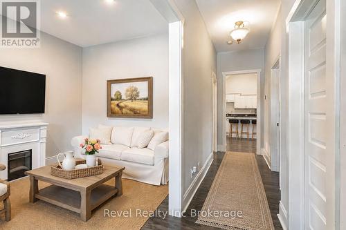 Virtually Staged - 31 Givins Street, Woodstock (Woodstock - North), ON - Indoor Photo Showing Living Room With Fireplace