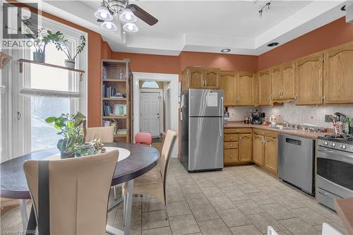 Kitchen featuring wood cabinetry, stainless steel appliances, tile flooring, and a recessed ceiling with lighting - 17 Scarfe Avenue, Brantford, ON - Indoor Photo Showing Other Room