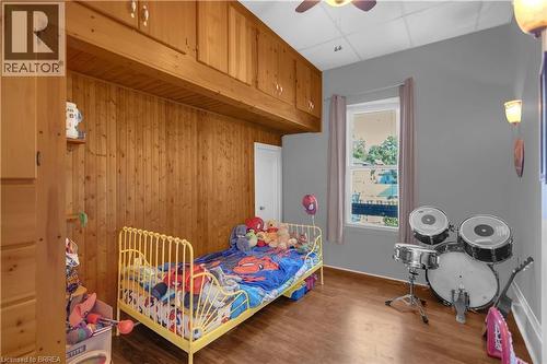 Room featuring wood-finish flooring and a partial wood-paneled wall - 17 Scarfe Avenue, Brantford, ON - Indoor Photo Showing Bedroom