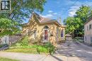Brick exterior with arched windows, a covered front porch, and an asphalt driveway - 17 Scarfe Avenue, Brantford, ON  - Outdoor 
