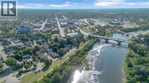 Aerial perspective showcasing a river, multiple bridges, a tree-lined residential area, and a commercial district with various buildings - 17 Scarfe Avenue, Brantford, ON - Outdoor With Body Of Water With View