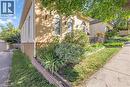 Brick exterior featuring arched windows, mature landscaping, and an established sidewalk - 17 Scarfe Avenue, Brantford, ON  - Outdoor 