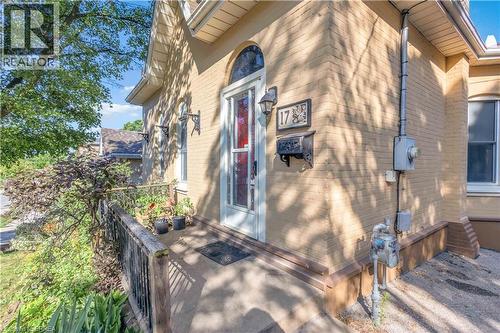 Brick exterior with arched entry door featuring stained glass accents - 17 Scarfe Avenue, Brantford, ON - Outdoor