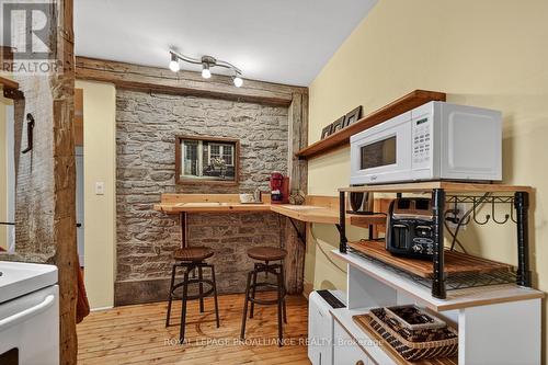 Stone accent wall in Kitchn - 34 Water Street W, Brockville, ON - Indoor With Fireplace