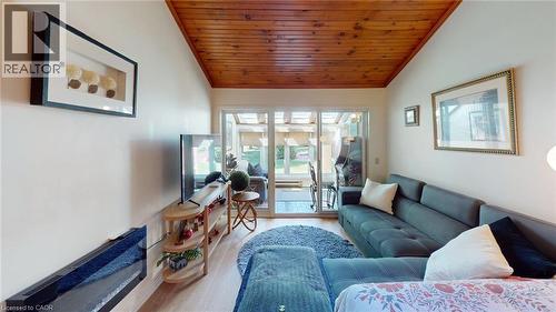 Vaulted wood-finish ceiling complementing light-toned walls and wood-finish flooring - 4101 Diana Park, Vineland, ON - Indoor Photo Showing Living Room