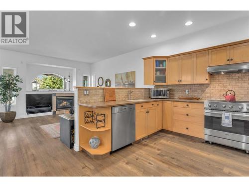Entetainers kitchen with high end stainless apppliances and Corian countertops. - 430 Mccarren Avenue, Kelowna, BC - Indoor Photo Showing Kitchen