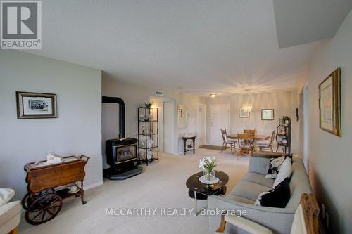 Pretty layout with cozy fireplace - 300 - 250 Robert Street, Shelburne, ON - Indoor Photo Showing Living Room With Fireplace