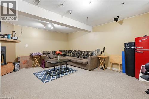 Spacious room featuring carpeting, light-toned walls, and exposed ceiling beams - 292 Mayview Court Unit# B, Waterloo, ON - Indoor