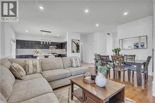 Open-concept living space featuring wood-finish flooring, recessed lighting, and a dining area - 73 Fitzgerald Drive, Cambridge, ON - Indoor Photo Showing Living Room