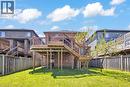 Elevated wood deck with baluster railings and staircase, brick exterior, and a spacious green lawn - 73 Fitzgerald Drive, Cambridge, ON  - Outdoor With Deck Patio Veranda 