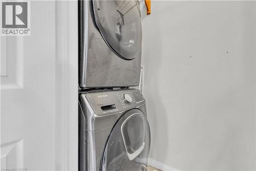 Stacked stainless steel laundry appliances - 73 Fitzgerald Drive, Cambridge, ON - Indoor Photo Showing Laundry Room
