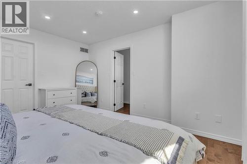 Bright interior space featuring light-colored walls and wood-finish flooring - 73 Fitzgerald Drive, Cambridge, ON - Indoor Photo Showing Bedroom