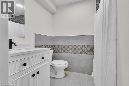 Bathroom featuring a white vanity with fluted detailing, black hardware, and a single-hole faucet - 73 Fitzgerald Drive, Cambridge, ON - Indoor Photo Showing Bathroom