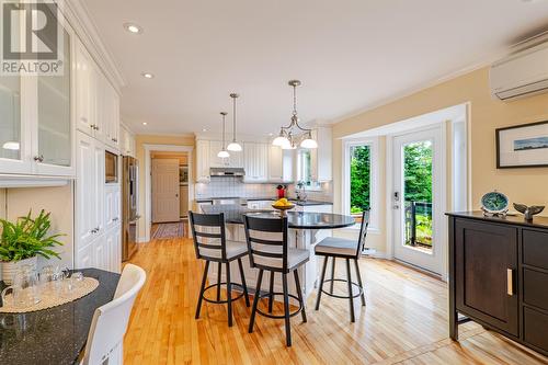 Gleaming hardwood flooring throughout, mini-split heat pump for comfort, and patio door leading to the stunning garden and deck. - 131-139 Marine Drive, Logy Bay, Middle Cove, Outer Cove, NL - Indoor
