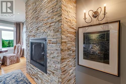 Stone feature wall with a propane fireplace - 131-139 Marine Drive, Logy Bay, Middle Cove, Outer Cove, NL - Indoor With Fireplace