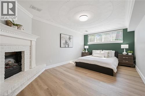16 Nipigon Street, Kitchener, ON - Indoor Photo Showing Bedroom With Fireplace
