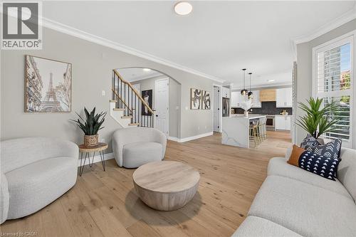 Spacious living area featuring wood-finish flooring and crown molding - 1533 Morse Place, Milton, ON - Indoor Photo Showing Living Room
